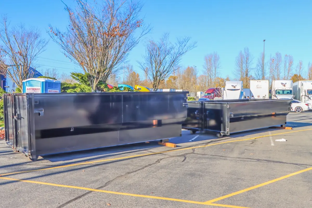 Professional dumpster rental service with roll-off container on residential driveway in Venus